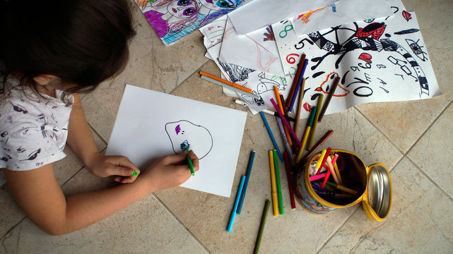 a child draws on a child's drawing