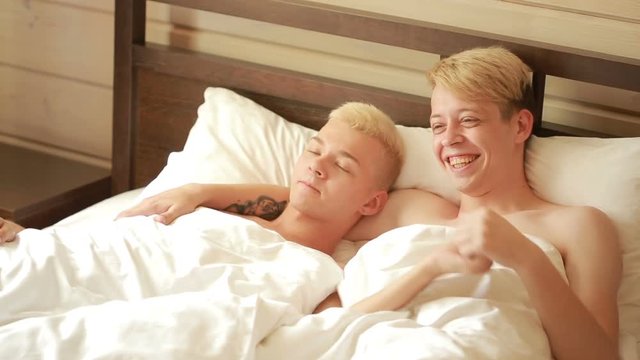 Homosexual couple lying on the bed. LGBT