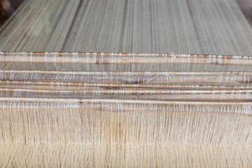 Close up loom with white yarn