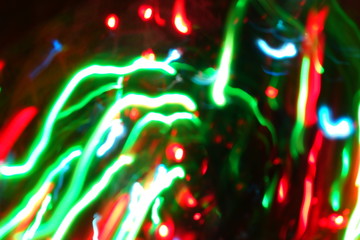 Chaotic lights in moriol blur out of focus - abstract photograph background.