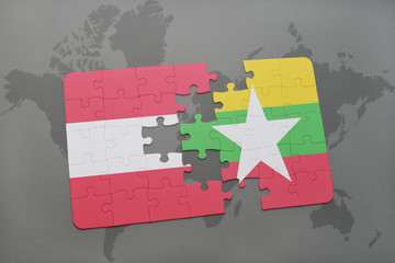 puzzle with the national flag of austria and myanmar on a world map background.