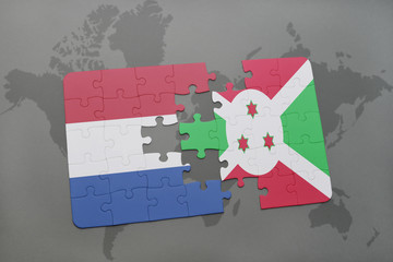 puzzle with the national flag of netherlands and burundi on a world map background.