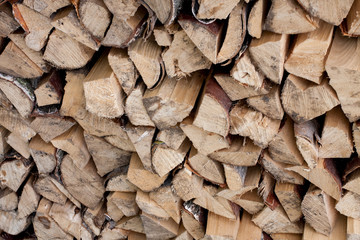 Stacked chopped firewood as background