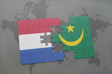 puzzle with the national flag of netherlands and mauritania on a world map background.