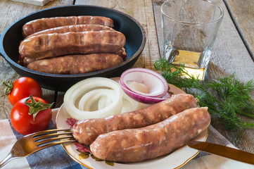Raw meat sausages before frying, with tomatos,onion,dill.