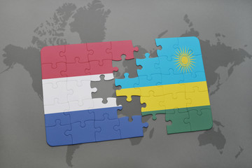 puzzle with the national flag of netherlands and rwanda on a world map background.