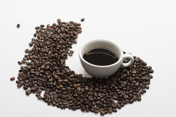 Cup with coffee and coffee beans