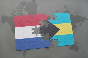 puzzle with the national flag of netherlands and bahamas on a world map background.