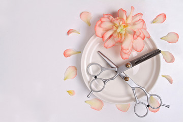 Scissors white background. Hairdresser salon concept. Creative arrangement made from flowers and pentals. Haircut accessories, flat lay, copy space