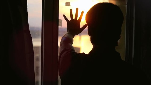 Man touch the sun on the window in slowmotion. 1920x1080