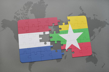 puzzle with the national flag of netherlands and myanmar on a world map background.