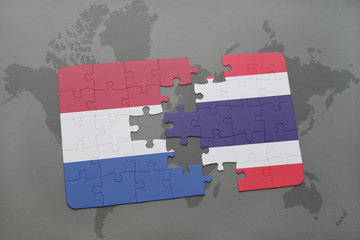 puzzle with the national flag of netherlands and thailand on a world map background.