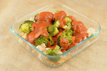 Casserole preparation with pasta, canned chicken chunks and steamed broccoli and marinara sauce