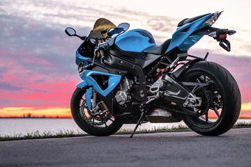 Foto op Plexiglas Sports motorcycle on the shore at sunset © Mikhail Glushkov