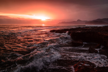 Storm sea at sunset on the south coast