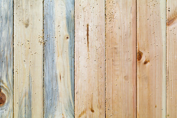 Pine boards different textures fit tightly. Located across the f