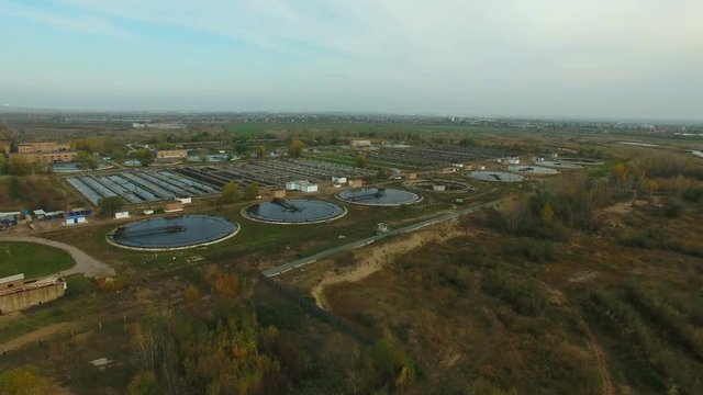 Aerial view of Wastewater treatment plant.  Drone moving forward. 4K Aerial stock footage  shot at autumn season time.
