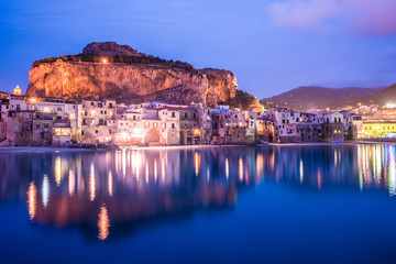 View on habour and old houses in Cefalu at night, Sicily. Beautiful townscape of old italian town. Travel photography. - 123597135