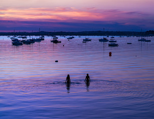 Naklejka premium Serene sunset over boats at Sandbanks, Poole, Dorset near Bourne