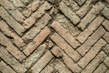 Texture of old weathered red brick sidewalk. 