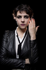 Goth style punk female wearing black manicure or press on nail art on fingernails