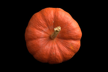 Top view of fresh orange pumpkin isolated on black background