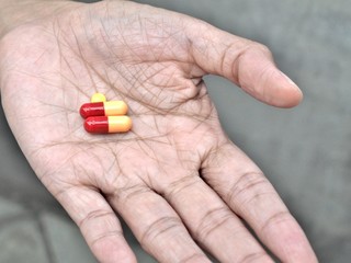 elder hand holding or offering pills, concept of healthy and medical.