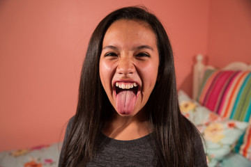 Funny hispanic girl sticking her tongue out