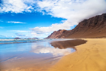 Fototapeta na wymiar Famara Beach, popular surfing beach in Lanzarote. Canary Islands