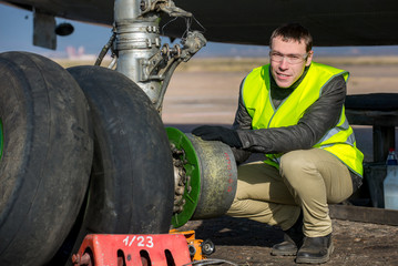 Engineer fixing aircraft's wheel