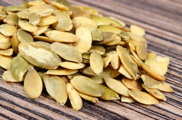 Pumpkin seeds on wooden background