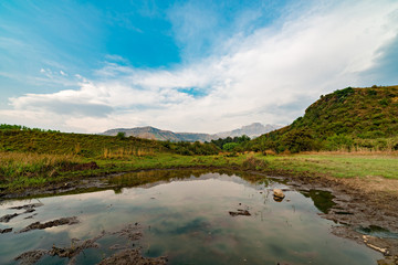 View over a dam alongside near Champagne Castle, in the Drakensberg. Cathkin Peak in the background.