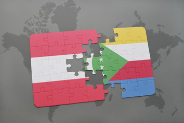 puzzle with the national flag of austria and comoros on a world map background.