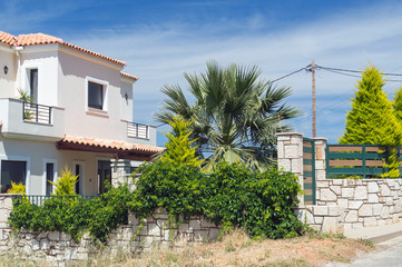 Fototapeta na wymiar Holiday villa with palm tree on Crete island, Greece