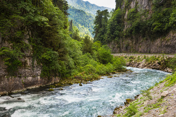 Fototapeta na wymiar Landscape in Abkhazia with Caucasian ridge and river
