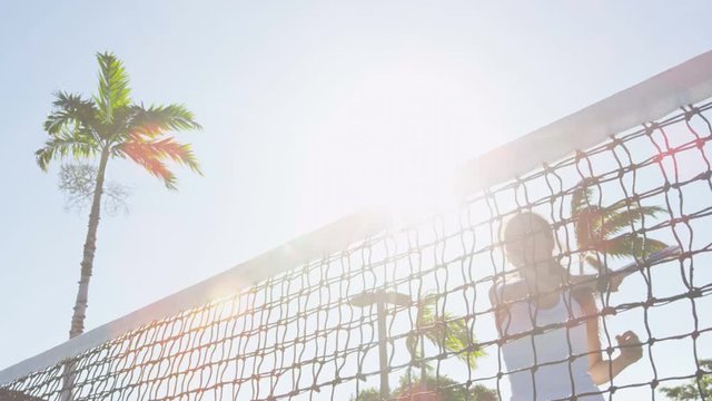 Tennis player woman hitting ball winning cheering celebrating victory. Female sport fitness athlete playing tennis on outdoors hard court. Happy girl in celebration of success and win. SLOW MOTION.