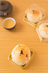 traditional chinese snack of preserved egg cakes with tea on a wood table