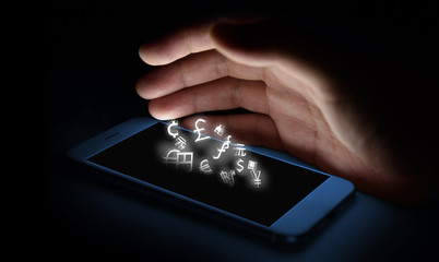 Currencies sign icon and smartphone screen and finger with black background , Currency concept , Fintech Investment Financial Internet Technology Concept.
