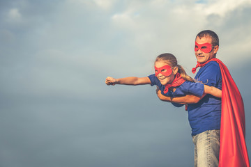 Fototapeta premium Father and daughter playing superhero outdoors at the day time.