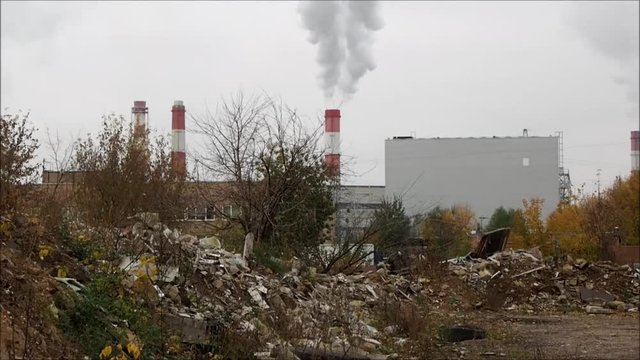Most landfills. Pipes and smoke into the sky, Industrial Zone, autumn trees. The concept of ecology, environmental pollution