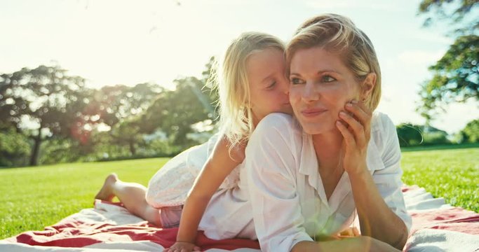 Mother and daughter relaxing together in the park