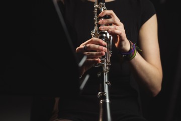 Woman playing a clarinet in music school