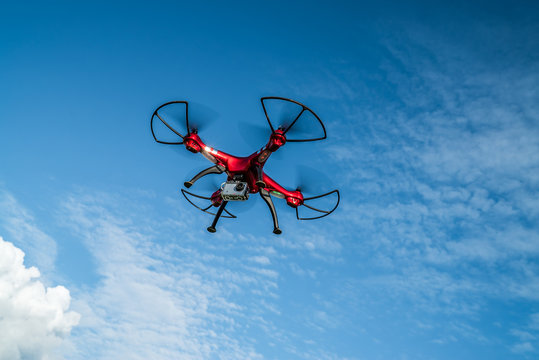 Roter Quadrocopter in der Luft unter blauem Himmel