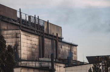 Working old factory during production. Emissions of harmful substances into the atmosphere pollution.