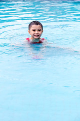 Fototapeta na wymiar Asian Chinese Little Boy Swimming In The Pool