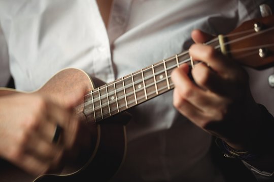 Close up of woman playing guitar