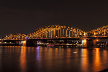Fototapeta na wymiar Illuminated bridge in Cologne at night