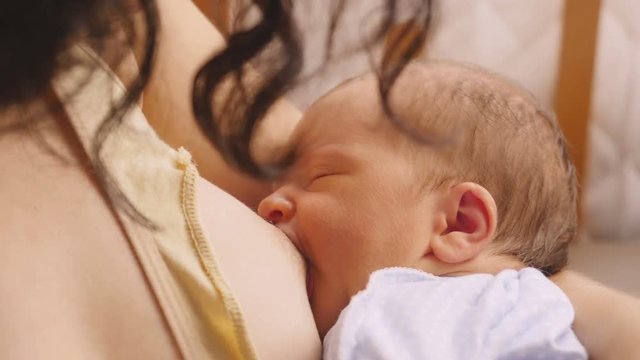 Mother breastfeeding her baby. 4K.
