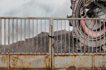 Giant bucket wheel excavator for digging the brown coal behind an iron gate