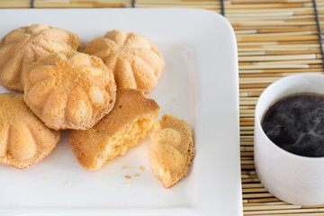 Egg cake, delicious dessert and black coffee in white dish on ba